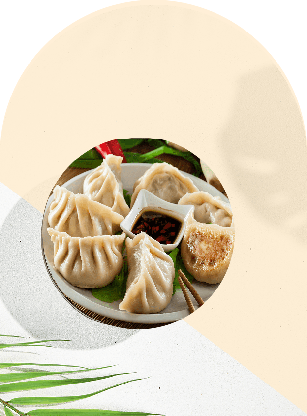 Plate of dumplings with dipping sauce.