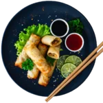 Spring rolls with sauces and lime slices.
