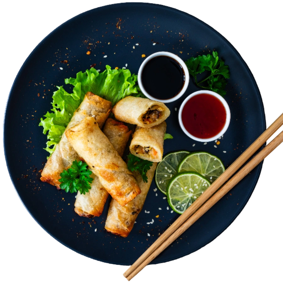 Spring rolls with sauces and lime slices.